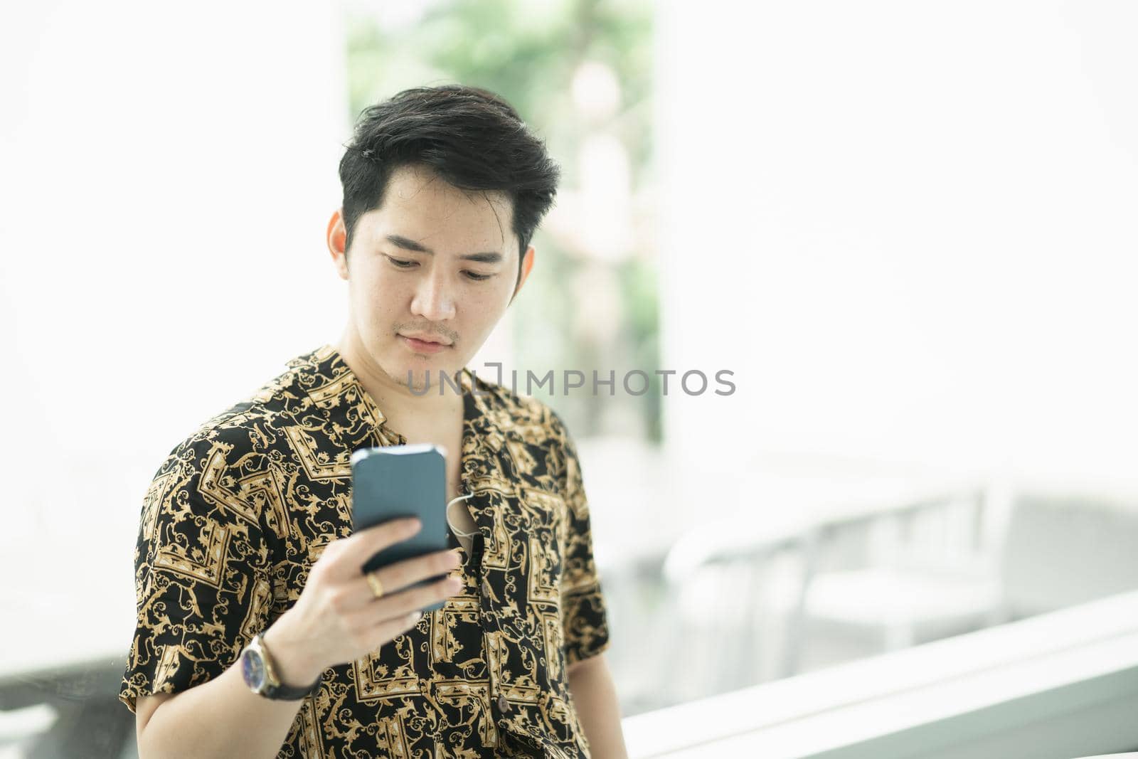 rich man using mobile phone and working with laptop at the cafe