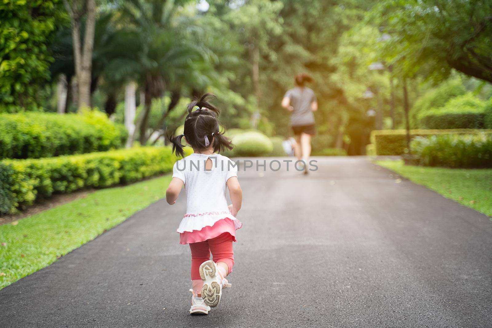 cute girl running at the garden