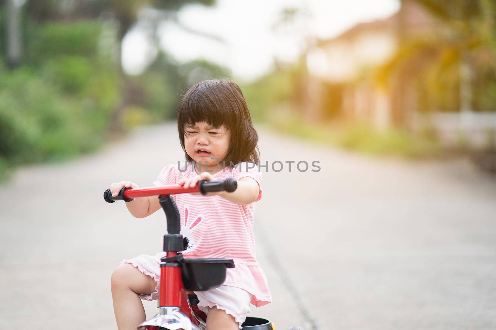 cute baby crying and riding bicycle