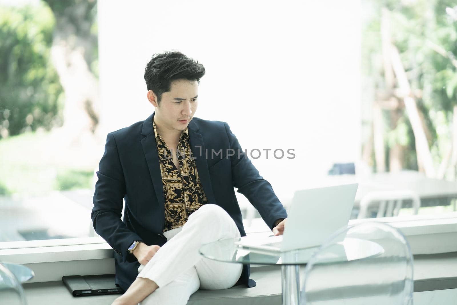 businessman working with laptop on the table in the cafe, business concept by Wmpix