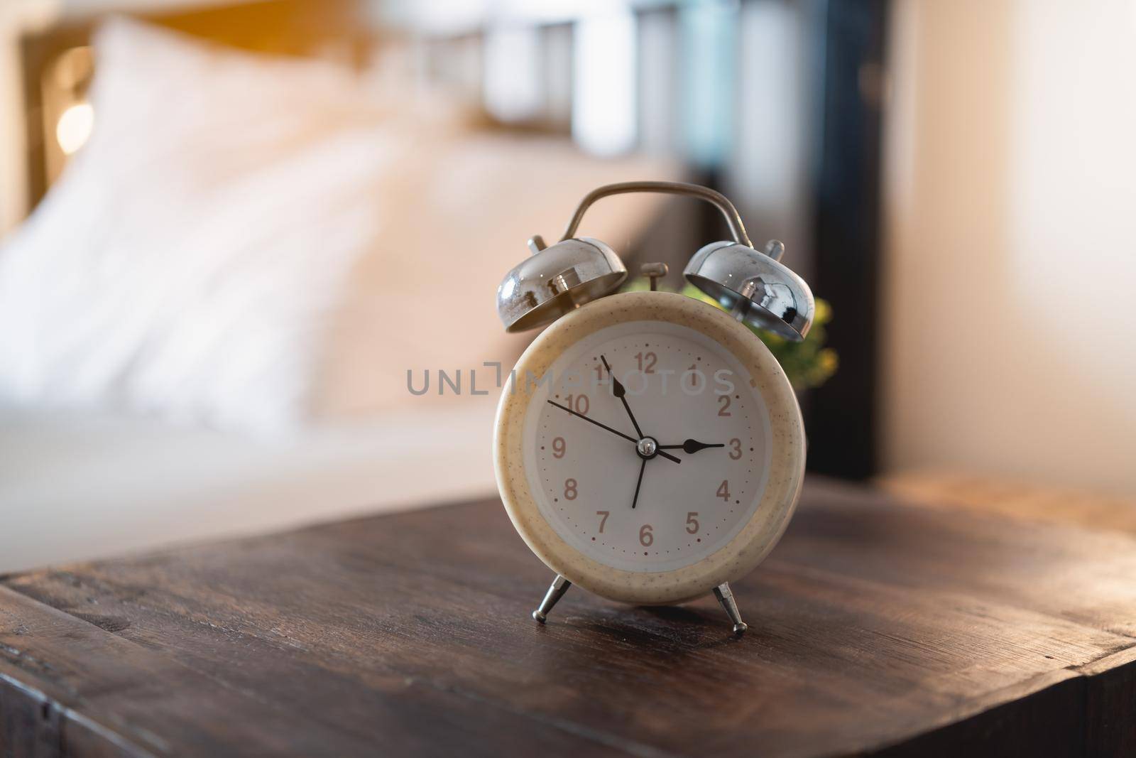 alarm clock on the table in the bedroom at home by Wmpix