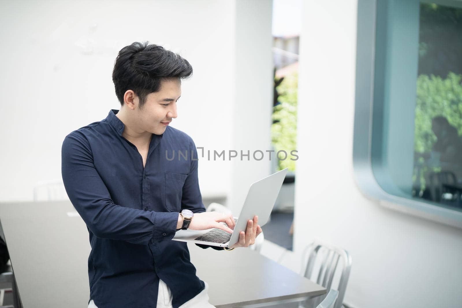 businessman working with laptop in the cafe, business concept by Wmpix