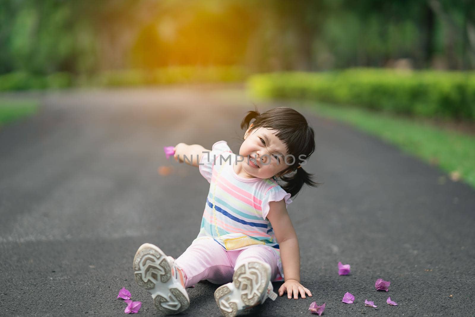 Cute baby sitting at the garden, cute baby outdoor activity concept