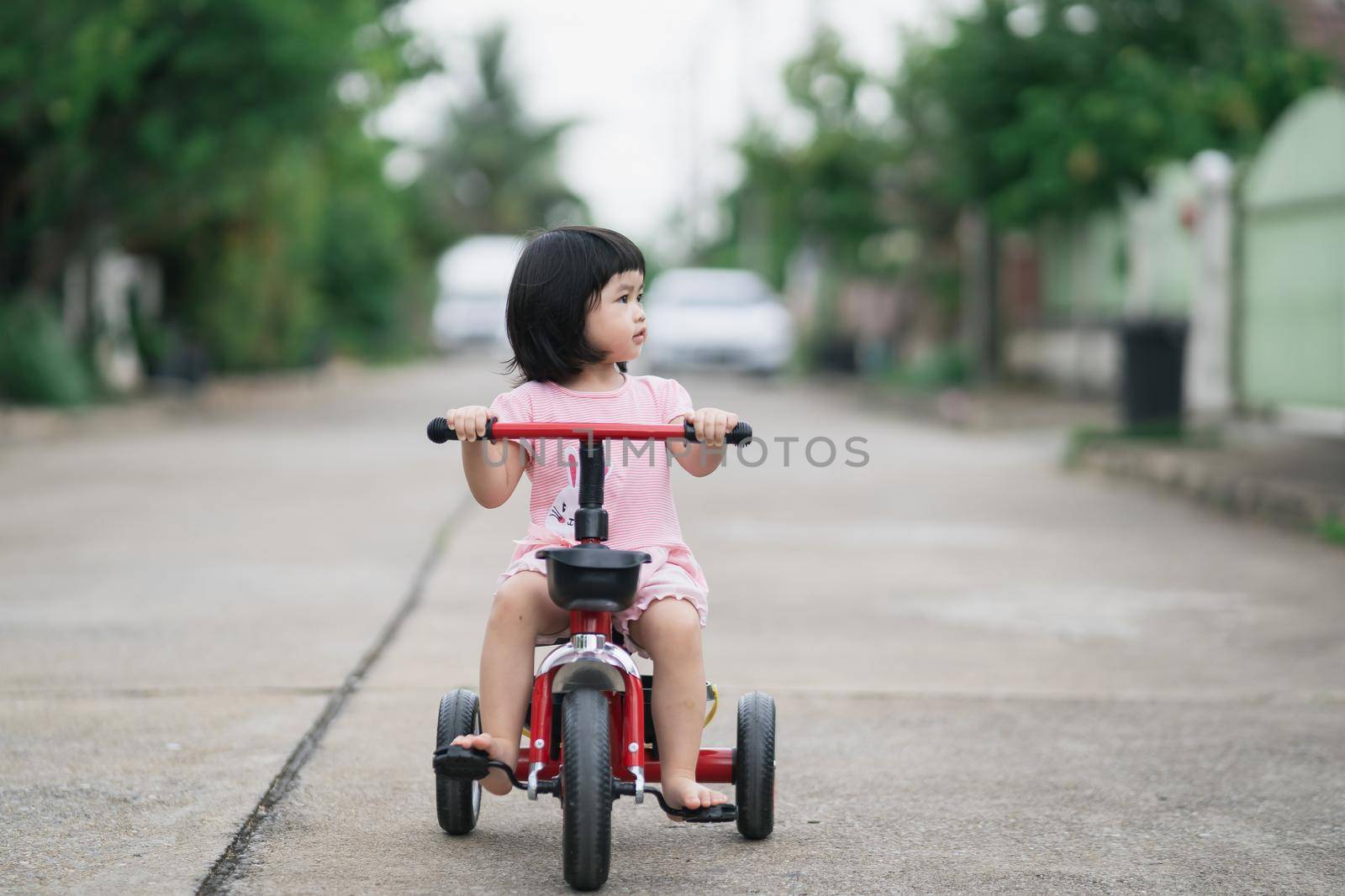 Cute children riding a bike. Kids enjoying a bicycle ride.