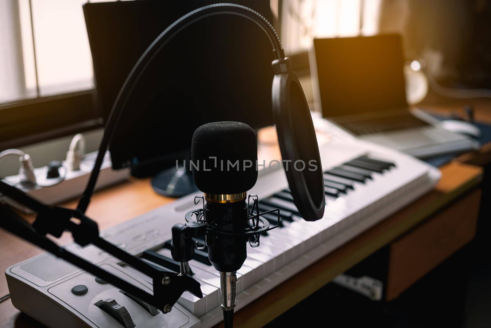 Close up of microphone and piano at the sound recording room