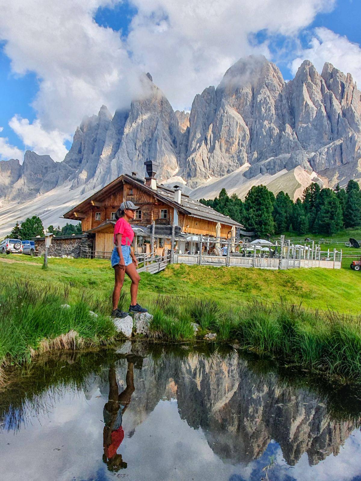 woman on vacation in the Italian Dolomites, View of the Geisler, Dolomites Val Di Funes Zanser Alm by fokkebok