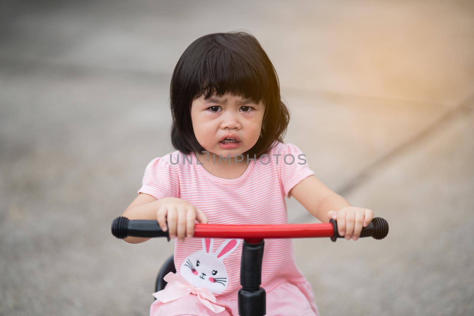cute baby crying and riding bicycle