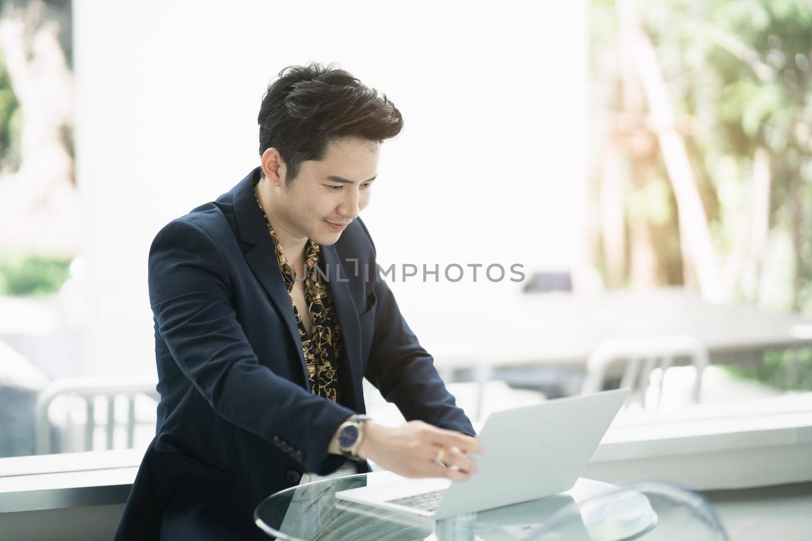 businessman working with laptop on the table in the cafe, business concept by Wmpix