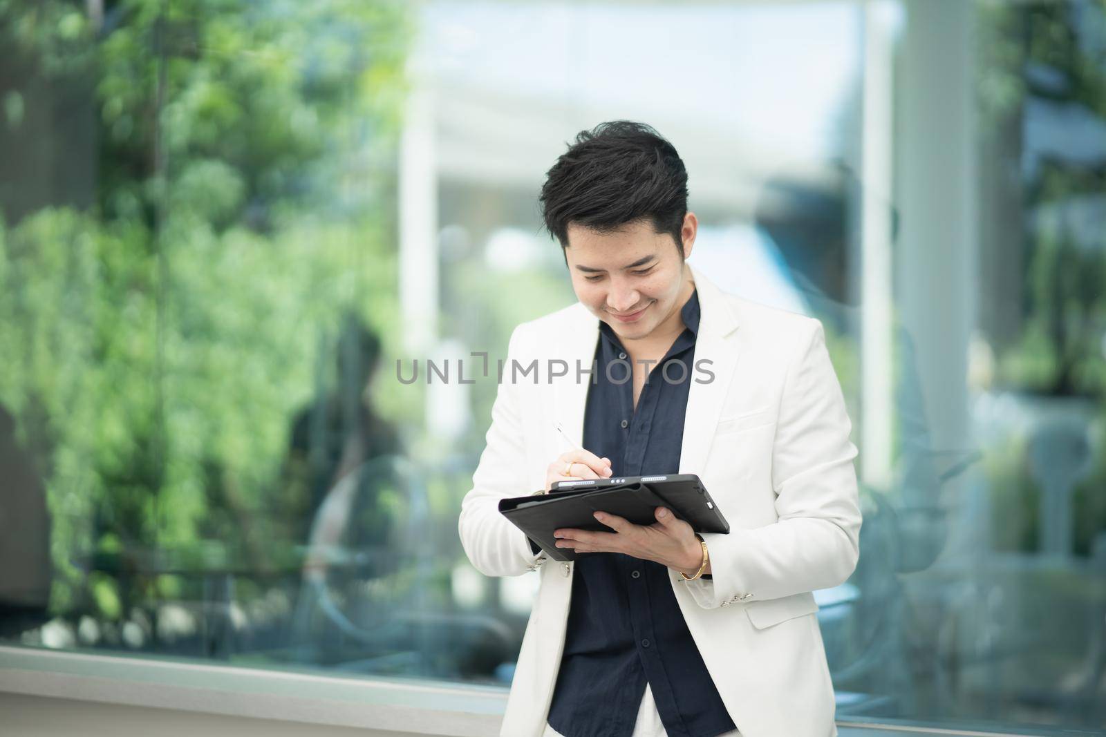 businessman working with tablet in the cafe, business concept by Wmpix