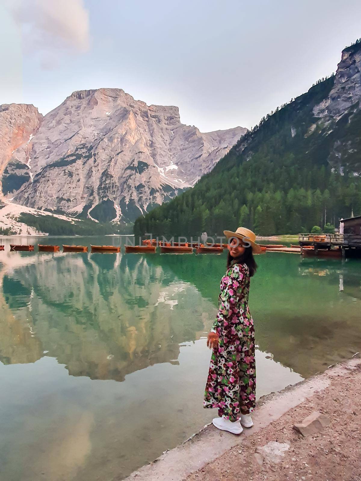 woman on vacation in the Italian Dolomites, Beautiful lake in the Italian Alps, Lago di Braies. 