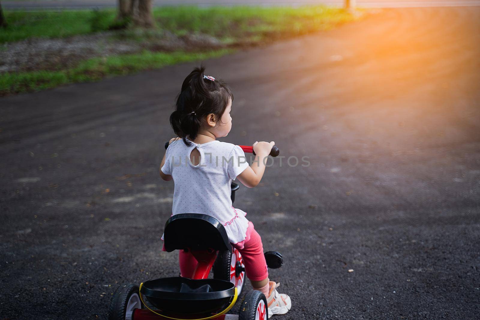 Cute children riding a bike. Kids enjoying a bicycle ride.