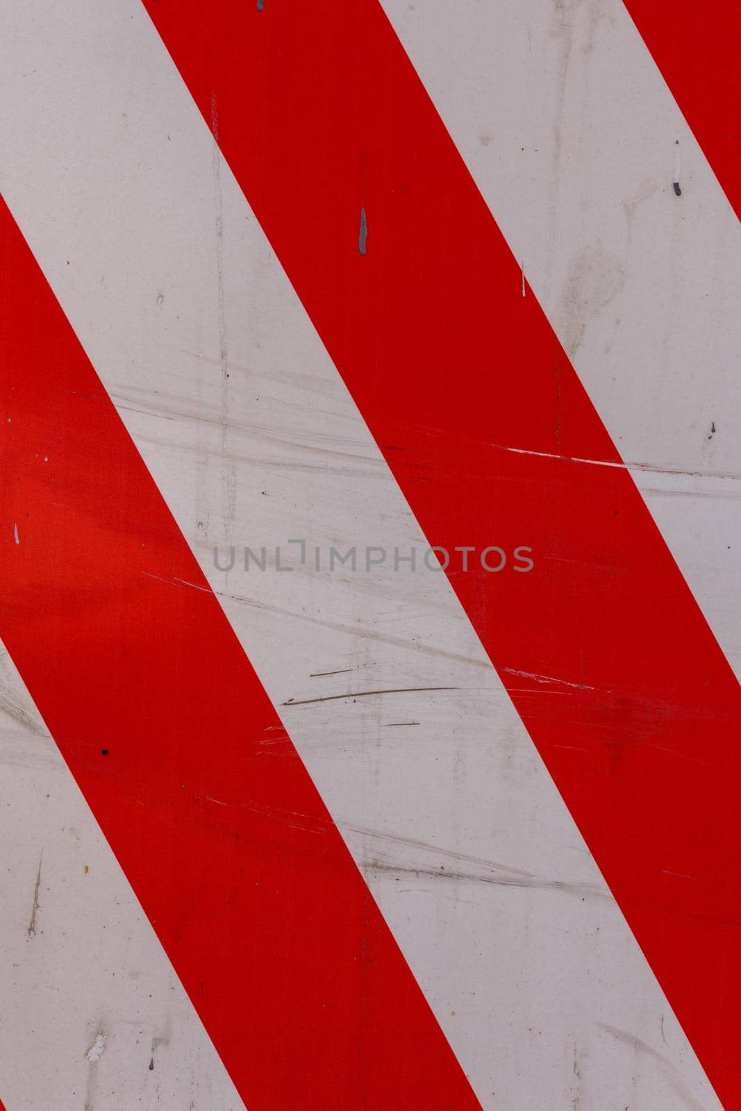 faded red and white diagonal stipes on flat steel sheet - caution road sign