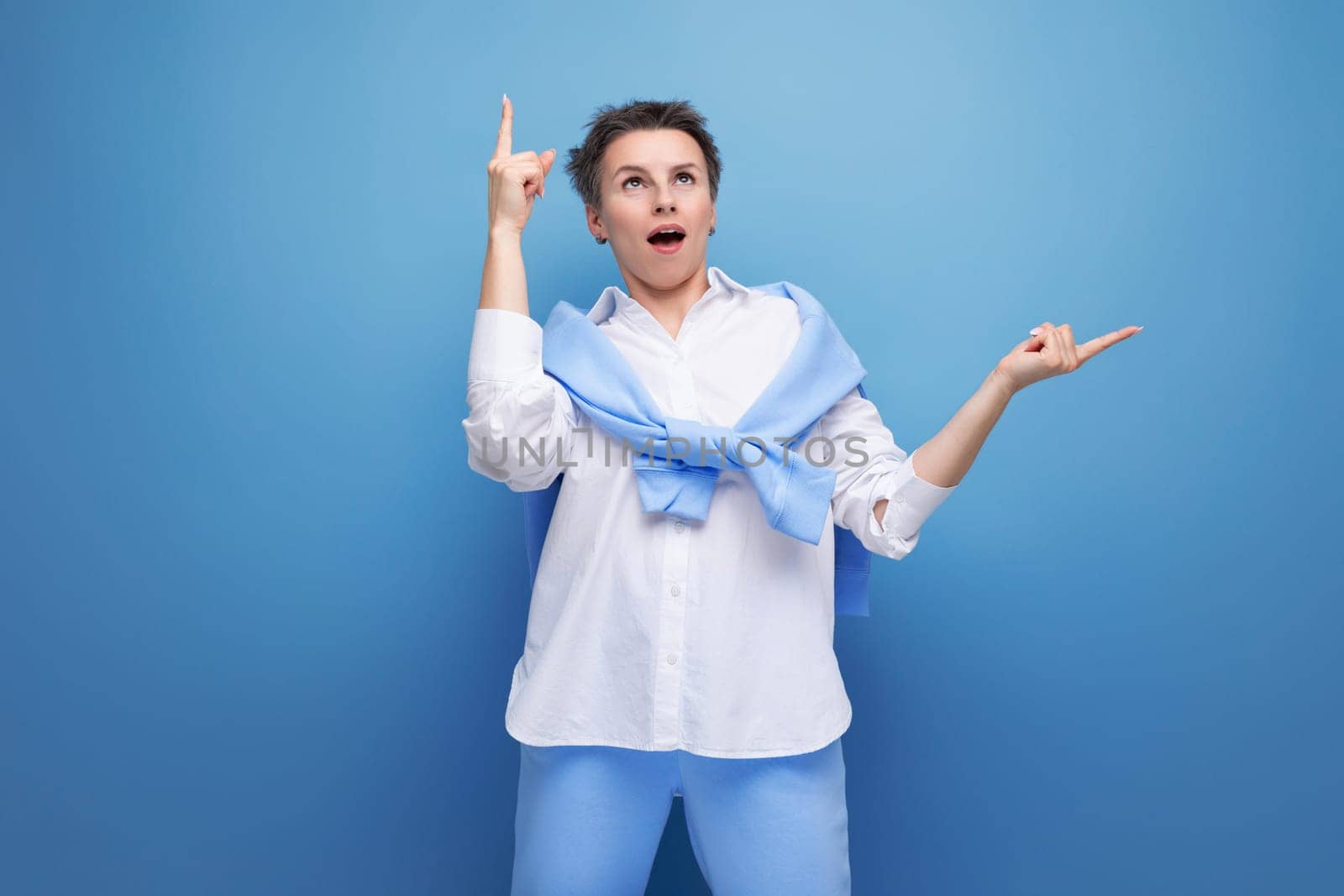 brilliant young woman with a short haircut in a white shirt and blue pants with an idea in her head.