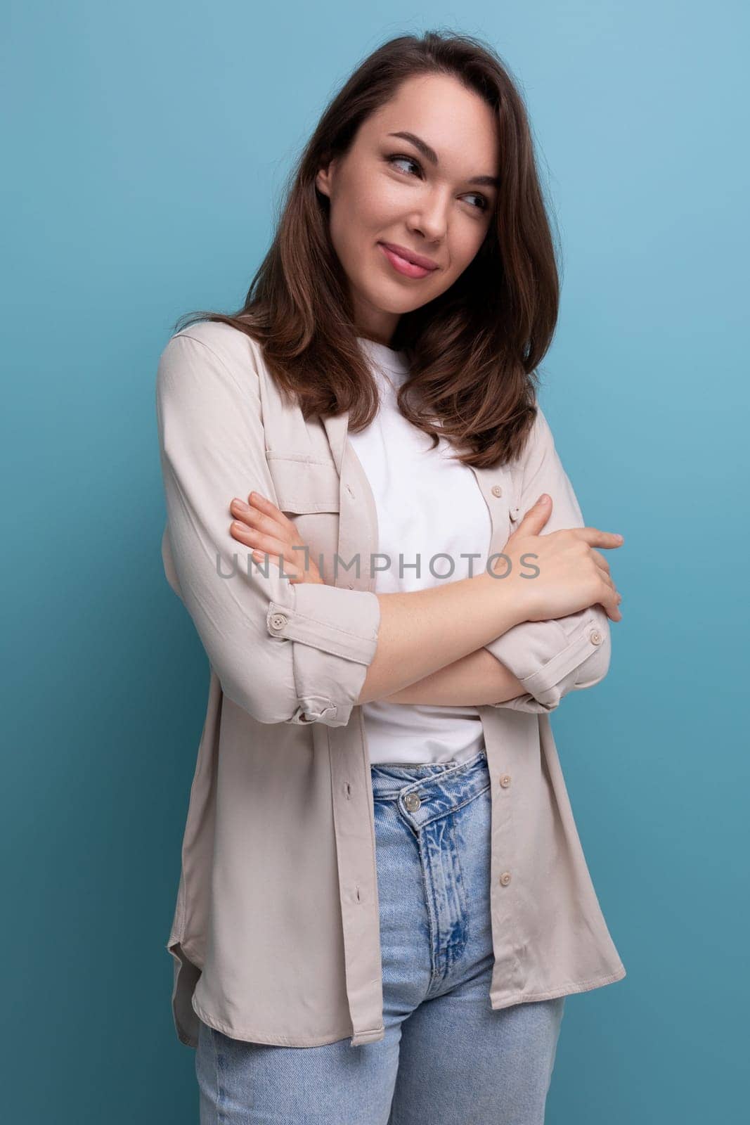 romantic young brunette female adult in casual shirt looks away.