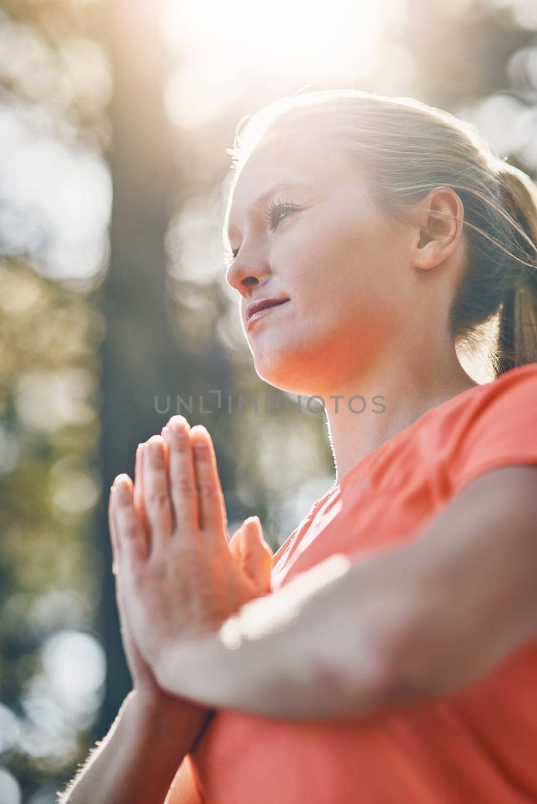 Hands, yoga and meditation with woman, praying with fitness outdoor and wellness, spiritual and low angle. Sunshine, female person meditate and zen with exercise, healing and mindfulness with prayer.