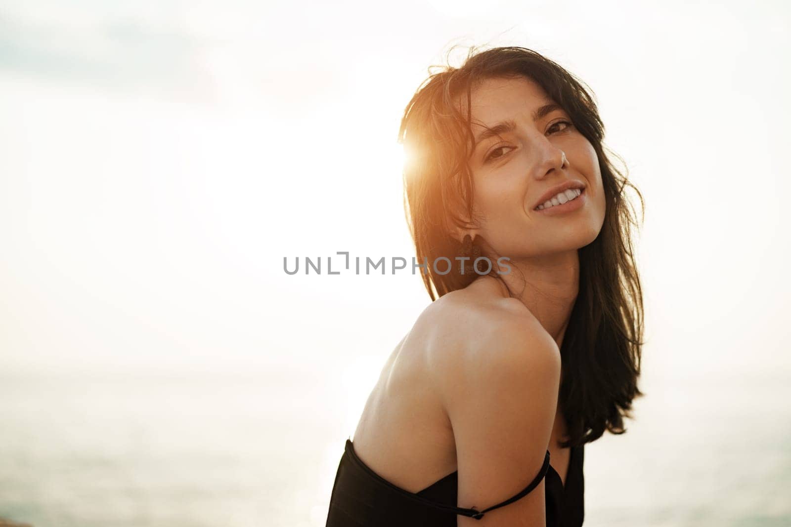 Young smiling woman outdoors portrait at beach by Fabrikasimf