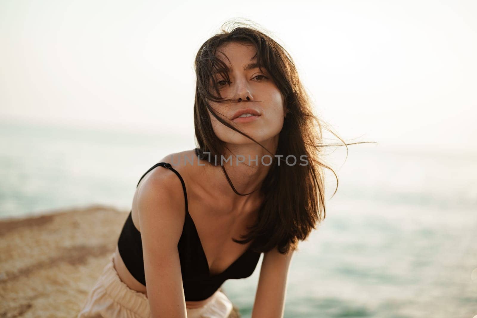 Young smiling woman outdoors portrait at beach by Fabrikasimf