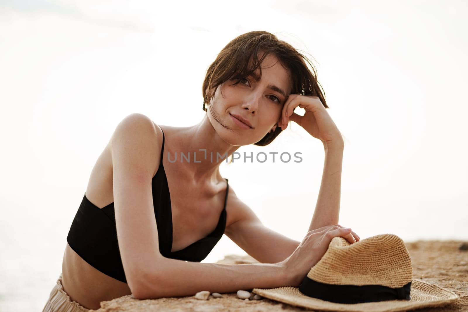 Young smiling woman outdoors portrait at beach by Fabrikasimf