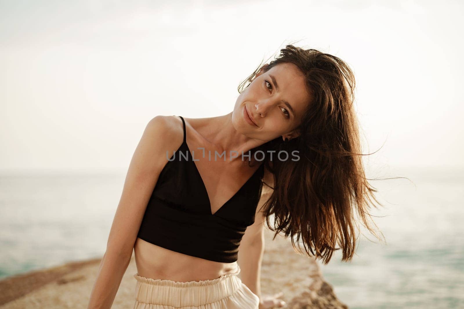 Young smiling woman outdoors portrait at beach by Fabrikasimf