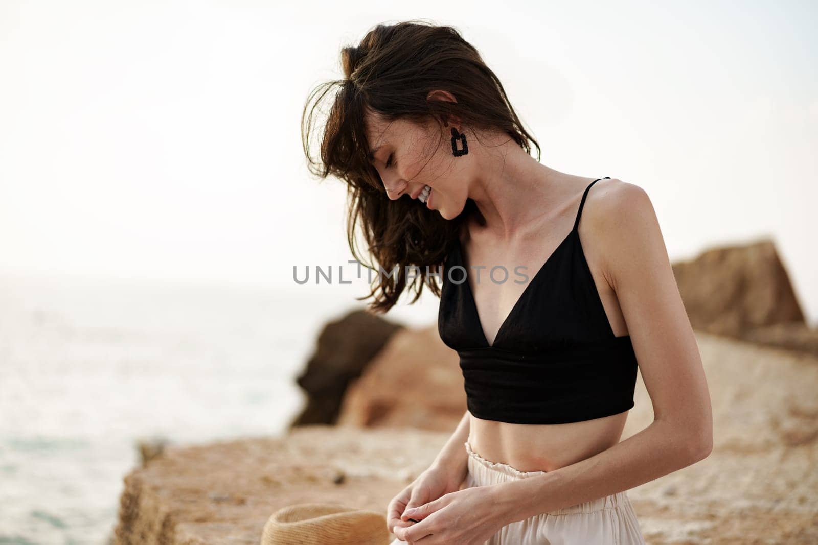 Young smiling woman outdoors portrait at beach by Fabrikasimf