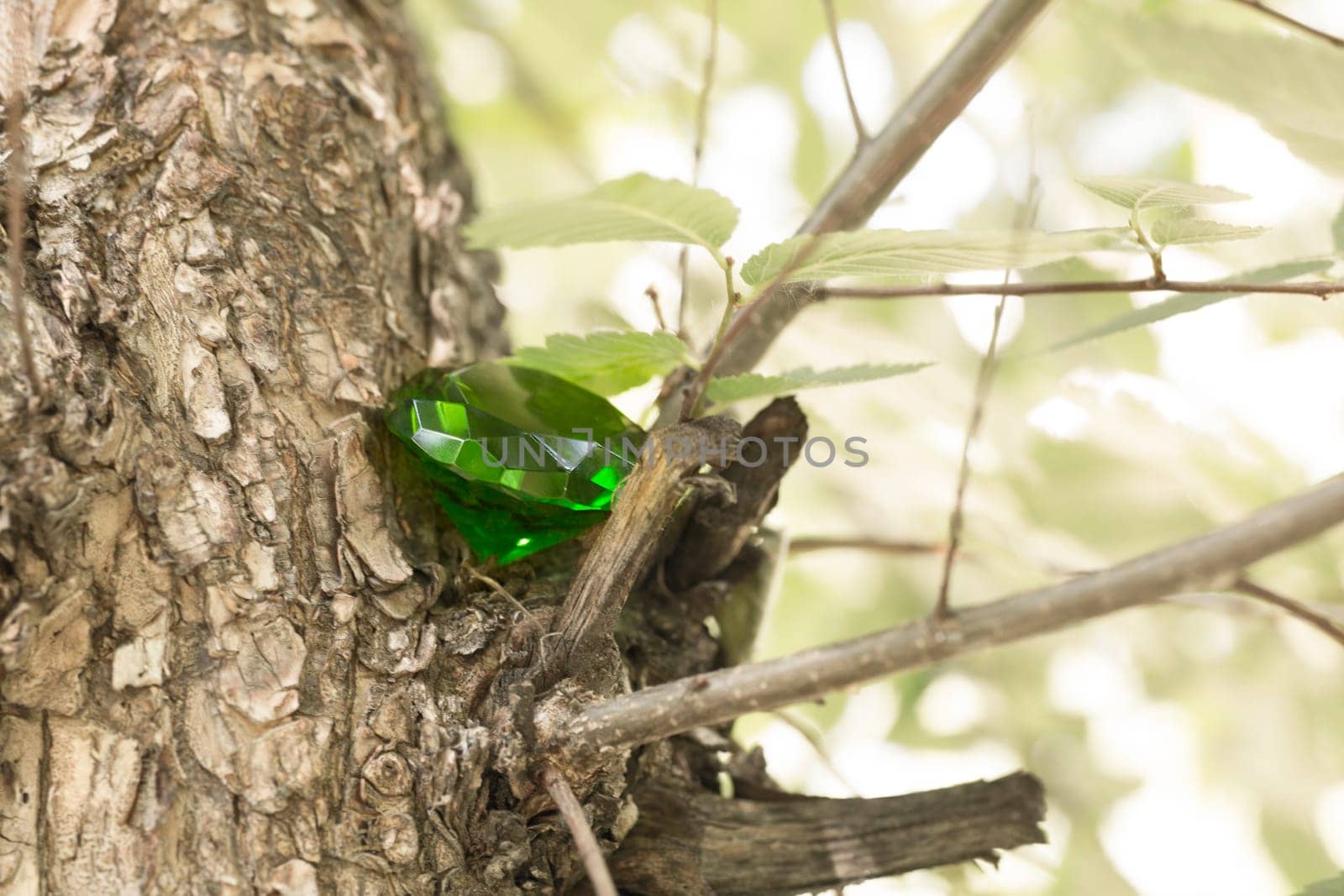 Glittering green magical crystal emerald in forest, diamond by lanart