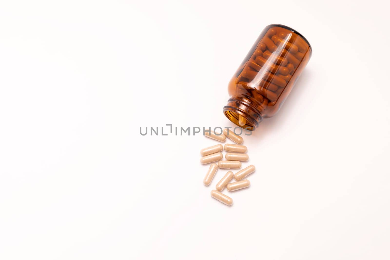 Flatly Group Of Scattered Slippery Elm Capsules, Dark Glass Bottle On White Background. Traditional, dietary supplement. Holistic remedy, medication Horizontal Plane, Copy Space For Text Top View.