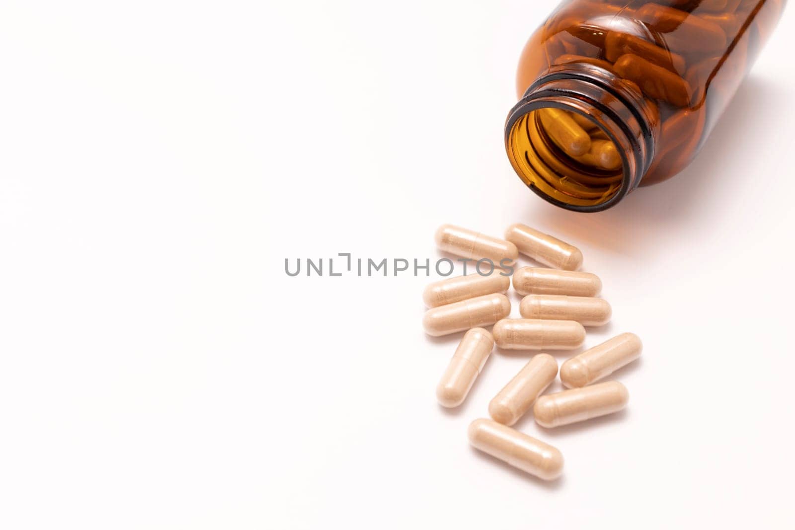 View From Above Capsules OF Slippery Elm, Brown Glass Bottle On White Background. Herbal Supplement, Medication. Ulmus Fulva, Natural Remedy Concept. Horizontal, Top View, Copy Space.