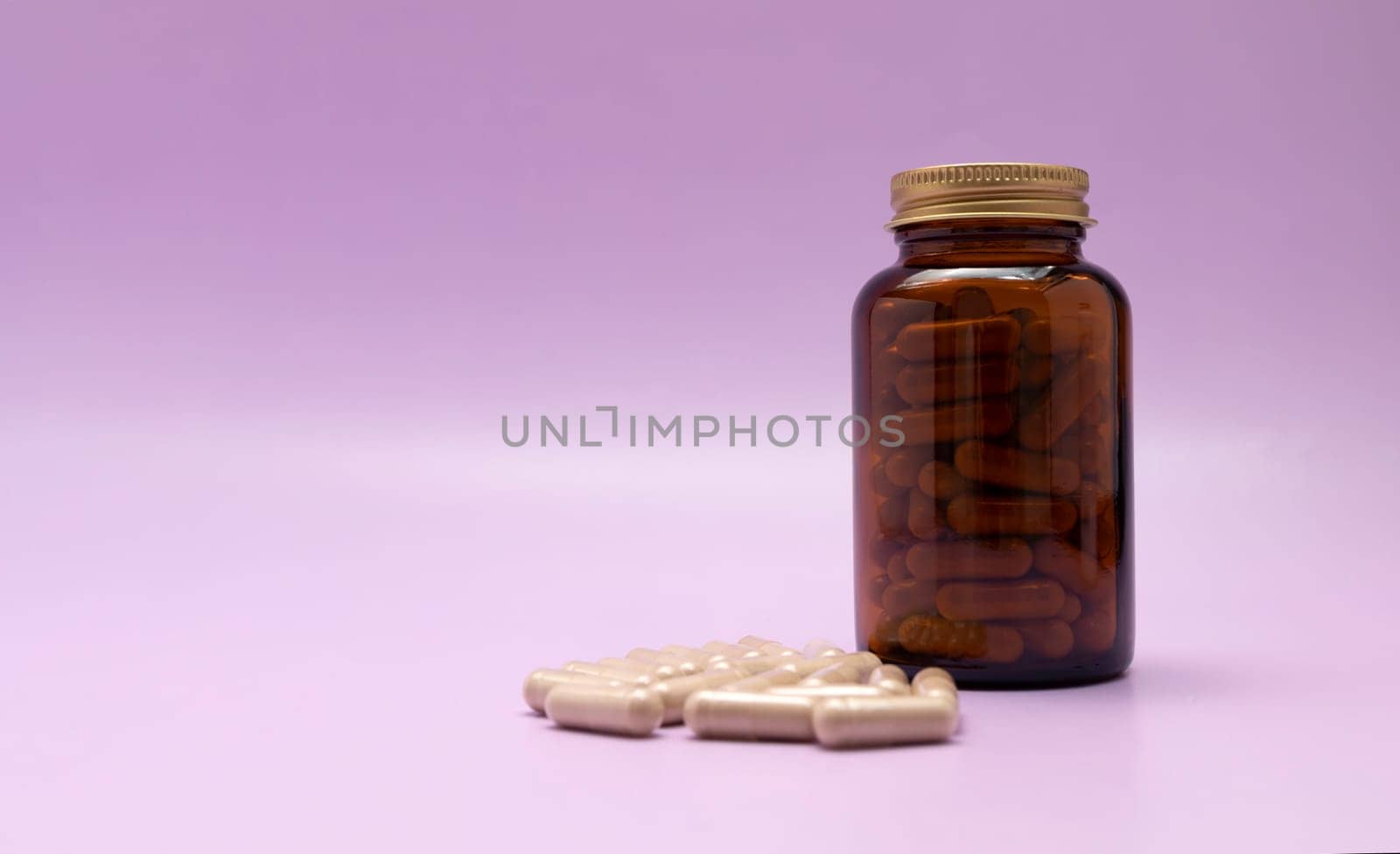 Brown Glass Bottle, Flattered Softgel Capsules OF Slippery Elm On Purple Violet Background, Copy Space for Text. Herbal Supplement, Ulmus Fulva, Natural Remedy. Horizontal plane.