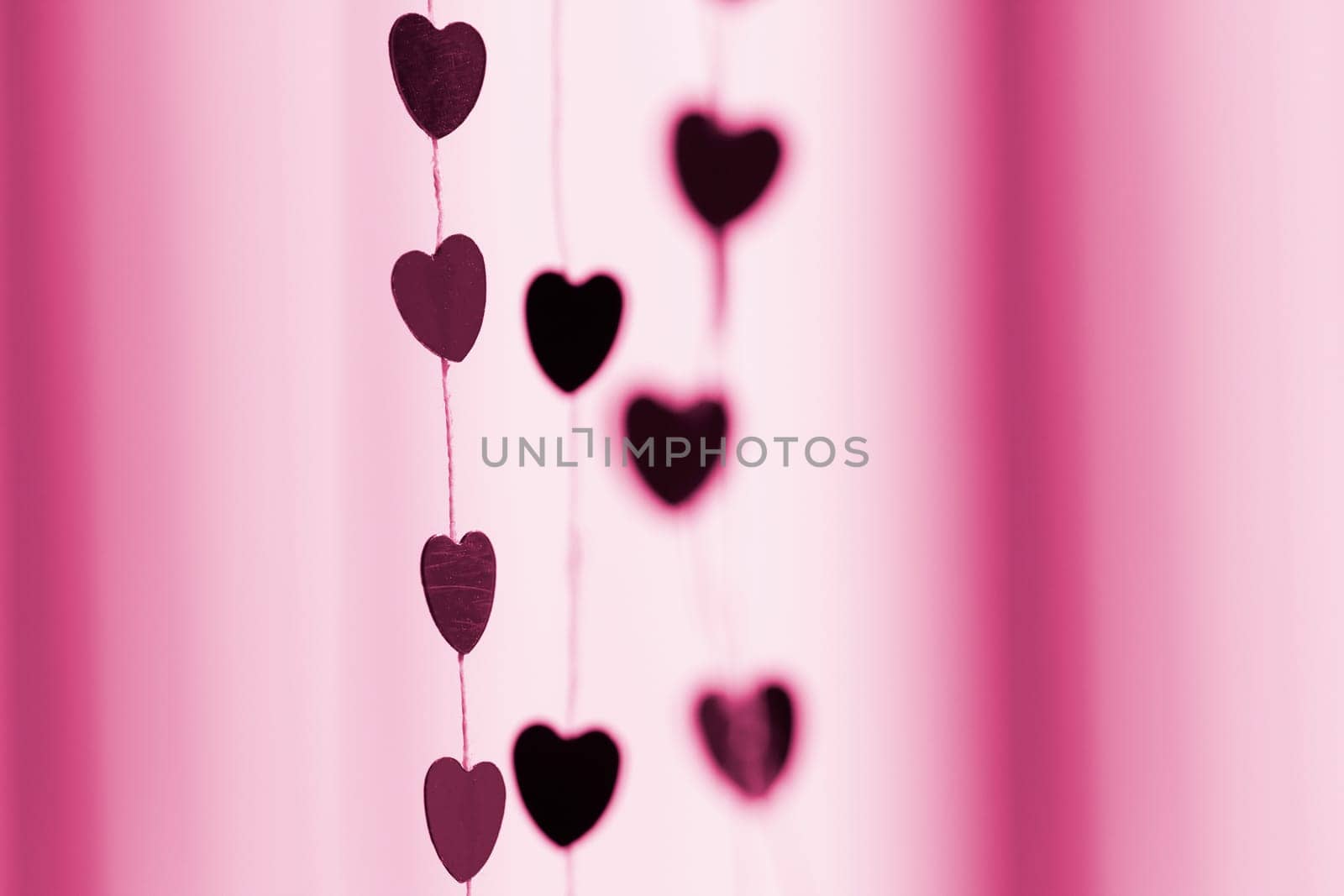 Colored shiny hearts hanging garland for Valentine's Day