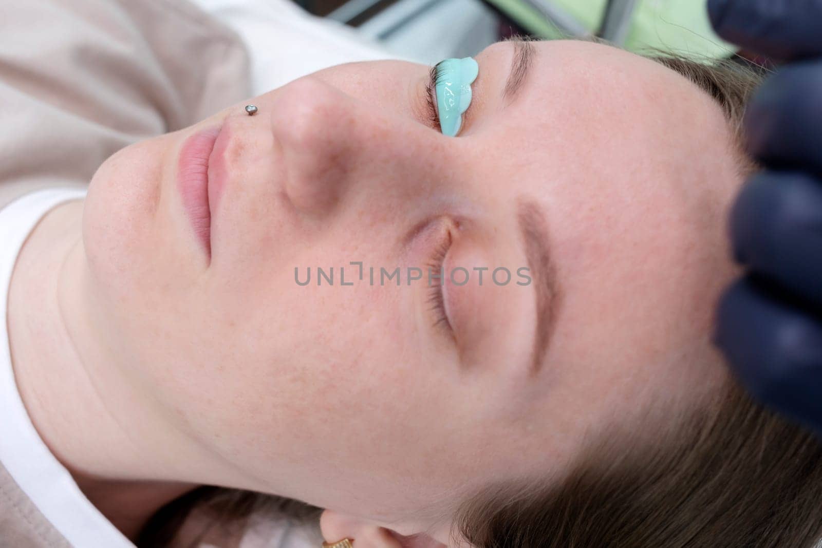Closeup Face Of White Woman With Laminating Eyelash, Rolled Hair On Silicone Roller. Curling, Staining, Extension Procedures For Lashes. Horizontal Plane. Step By Step. High Quality Photo