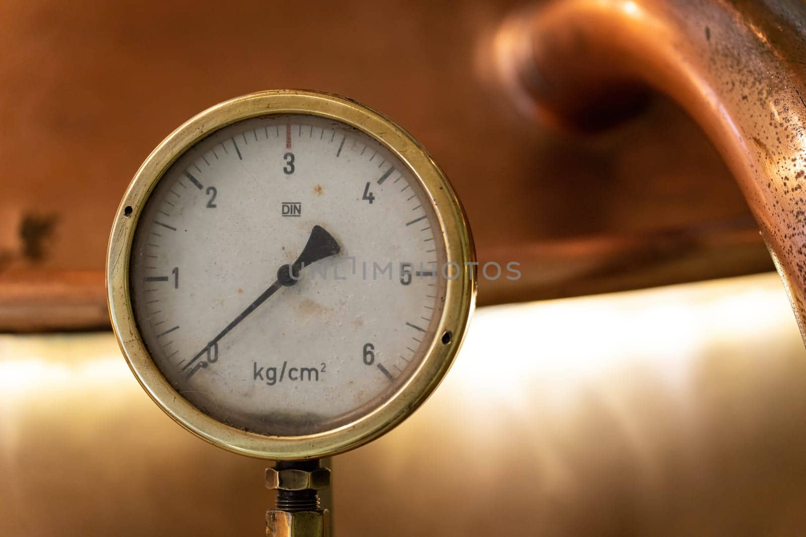 Close-up of single metal instrument of measurement on beer fermentation tank, perfect for craft beer brewing enthusiasts