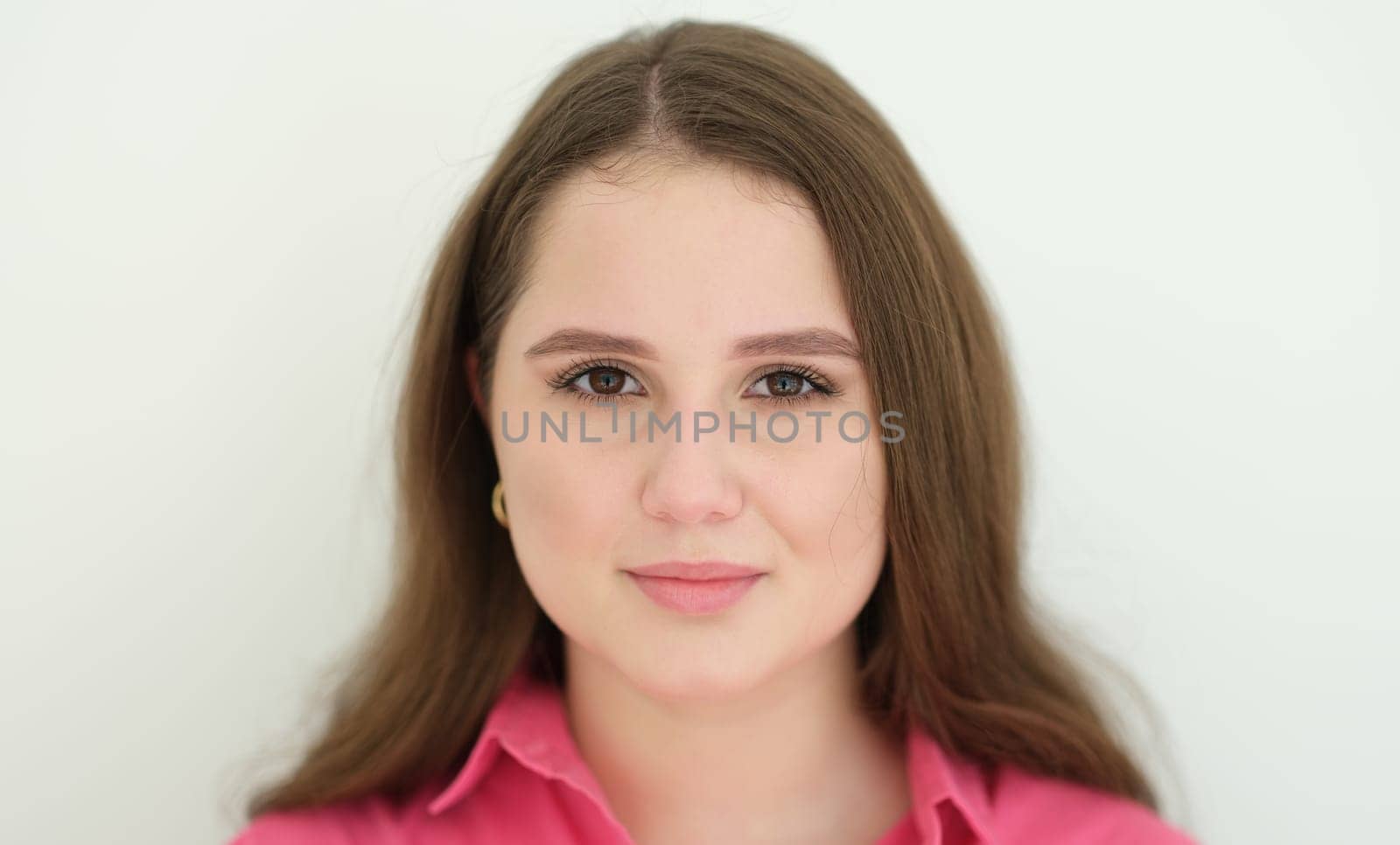 Portrait of young beautiful woman with dark long hair. Ordinary people concept