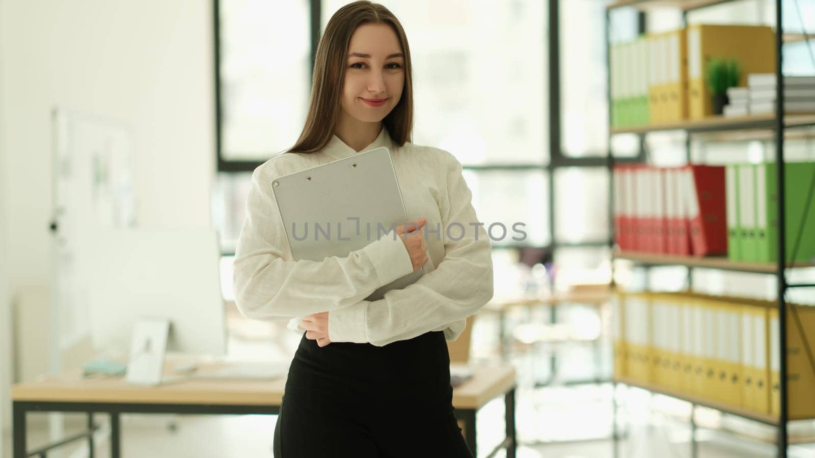 Woman manager with clipboard in hands in office portrait. Professional career growth in business concept