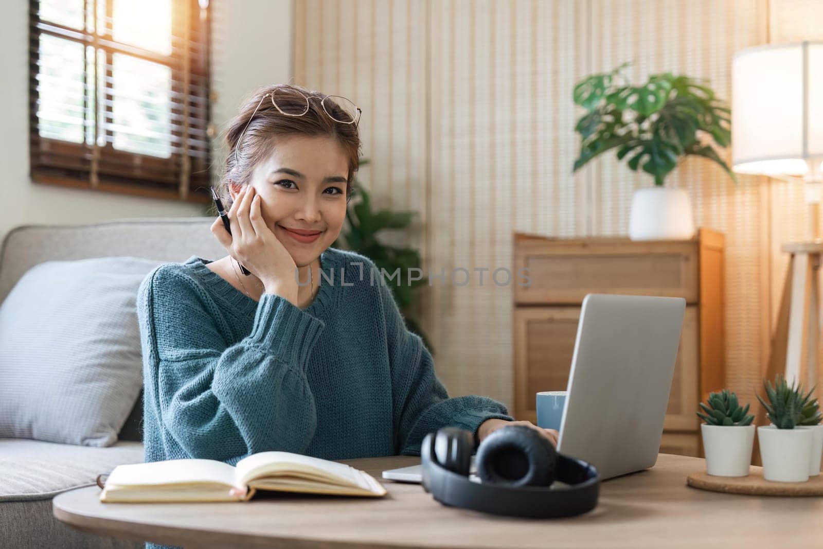 Image of woman cheery happy positive cute beautiful business woman sit indoors in home using laptop computer by nateemee