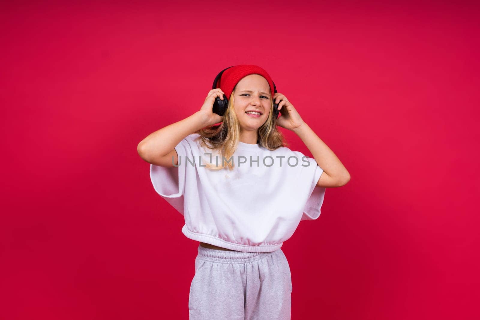 Child music concept. Teenager girl dance in rhythm of melody, listens song in headphones