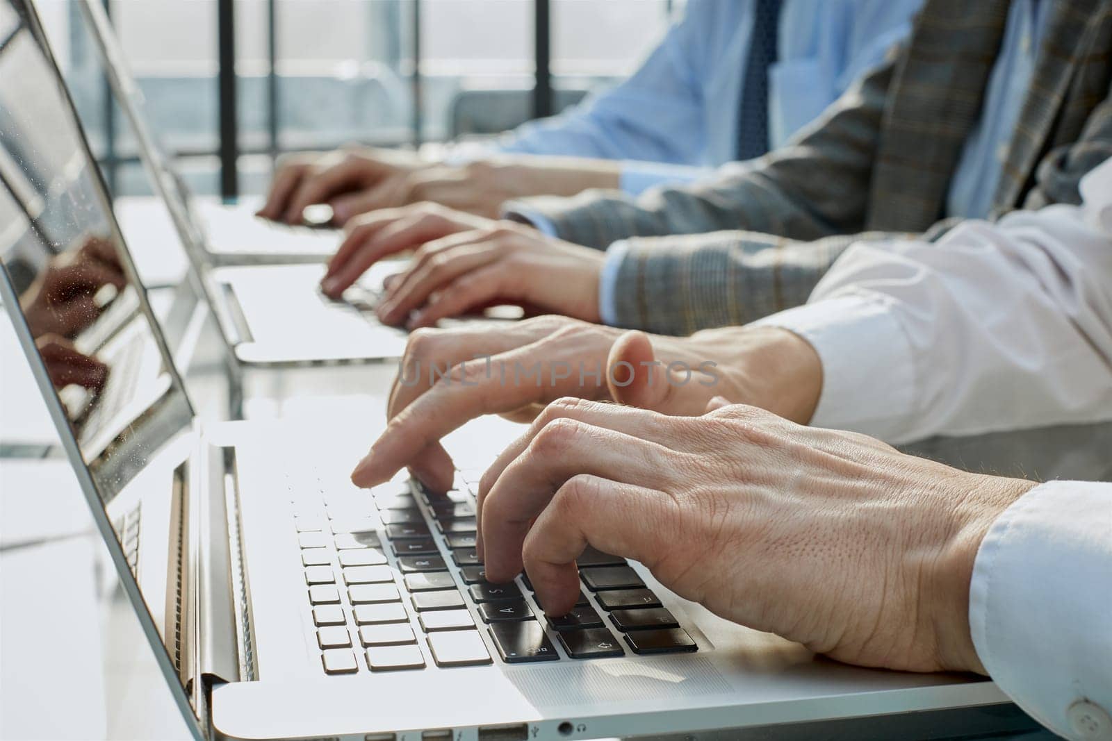 man working at office hand on keyboard close up