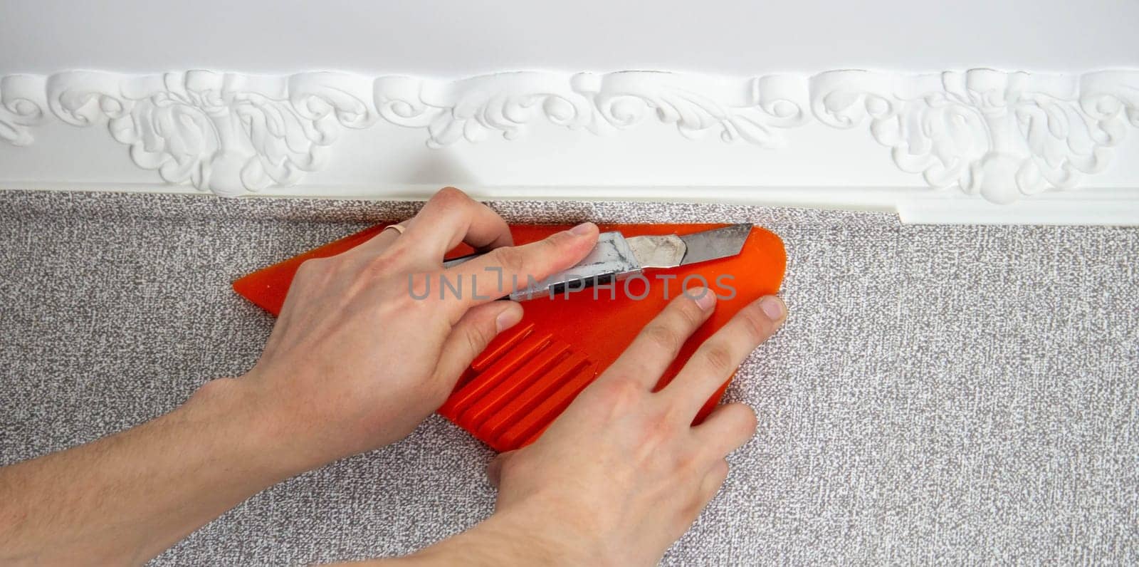 A man glues wallpaper, repairs the house. Selective focus