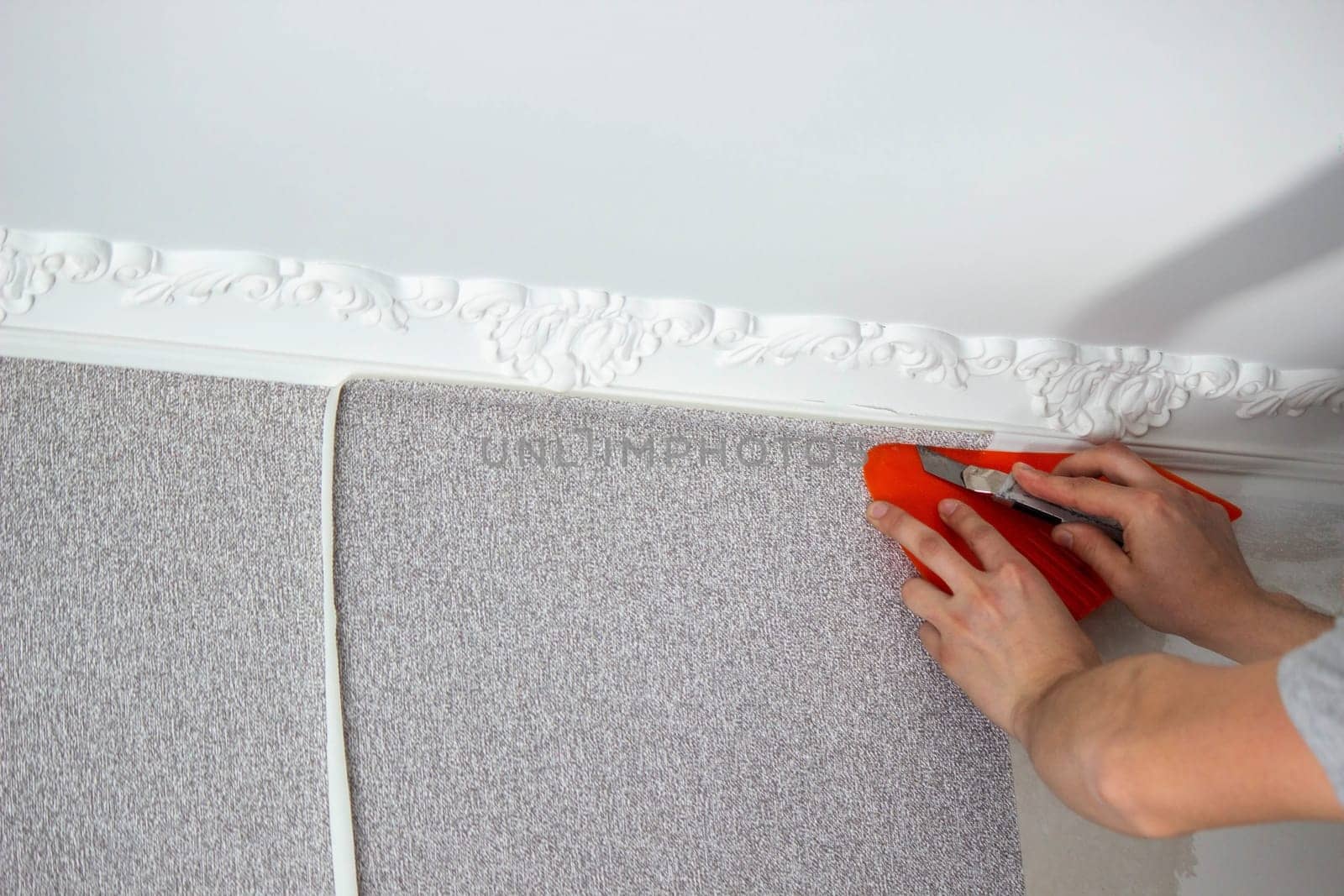 A man glues wallpaper, repairs the house. Selective focus