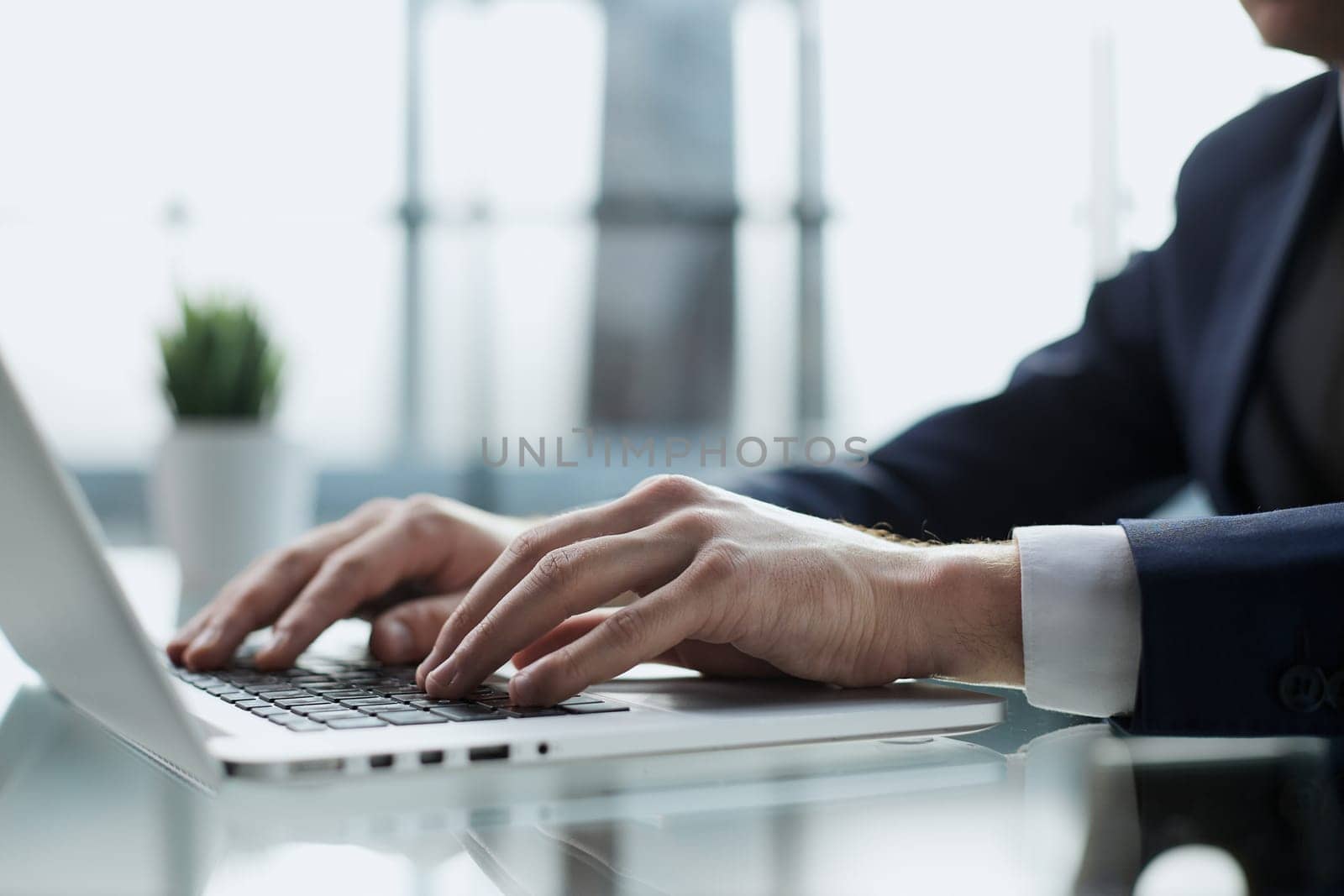Young man working on computer at table in office, closeup. Banner design