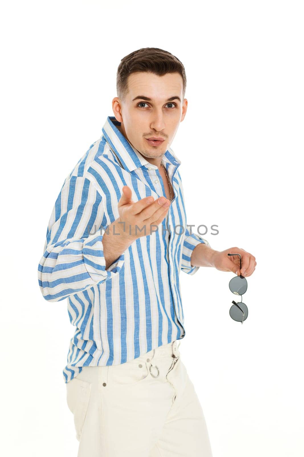 handsome young man in sunglasses and blue striped shirt isolated on white background. Summer fashion