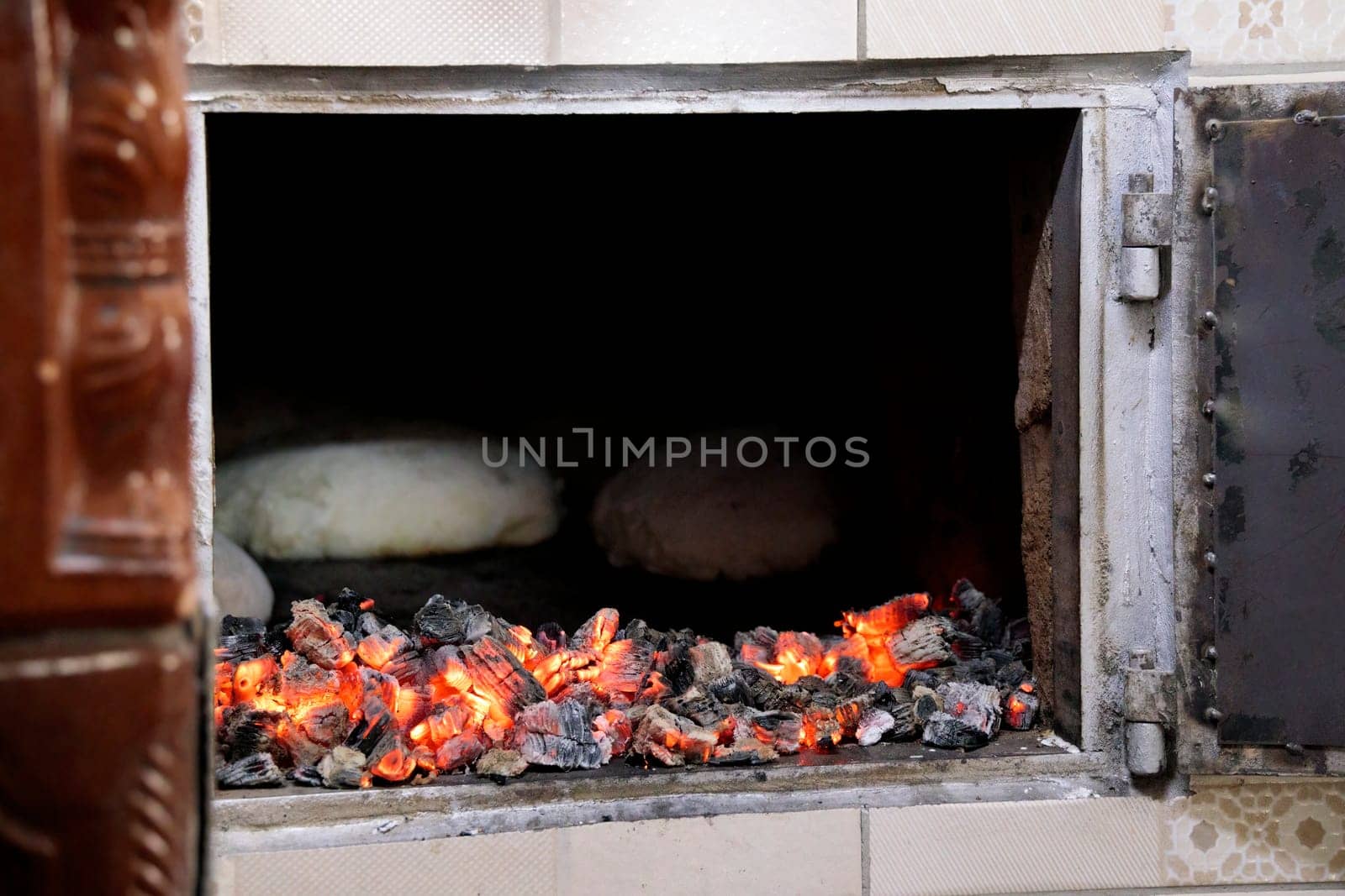 Home made bread roasting in to a traditional wood fire in a village