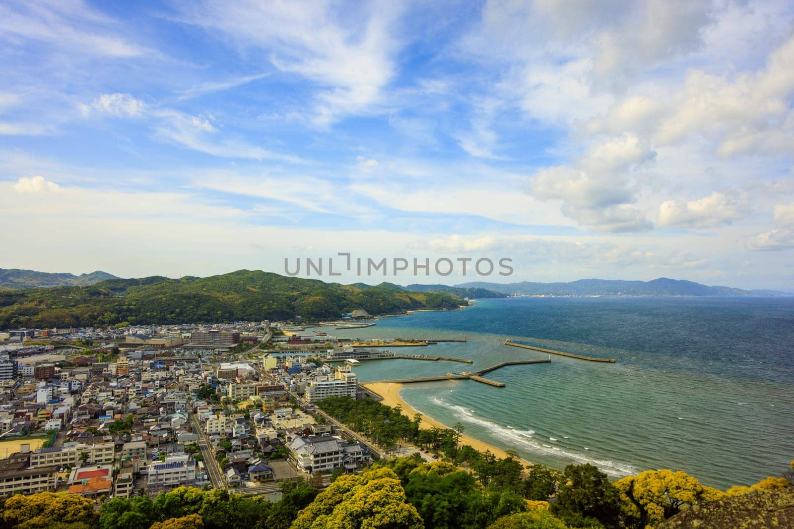 Clouds over beachfront town of Sumoto on Awaji Island on sunny day. High quality photo