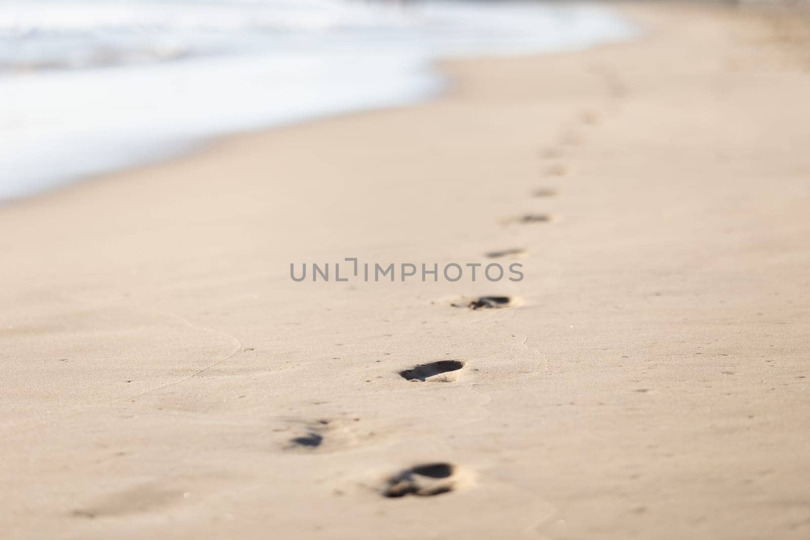 footprints on the wet sand. Mid shot