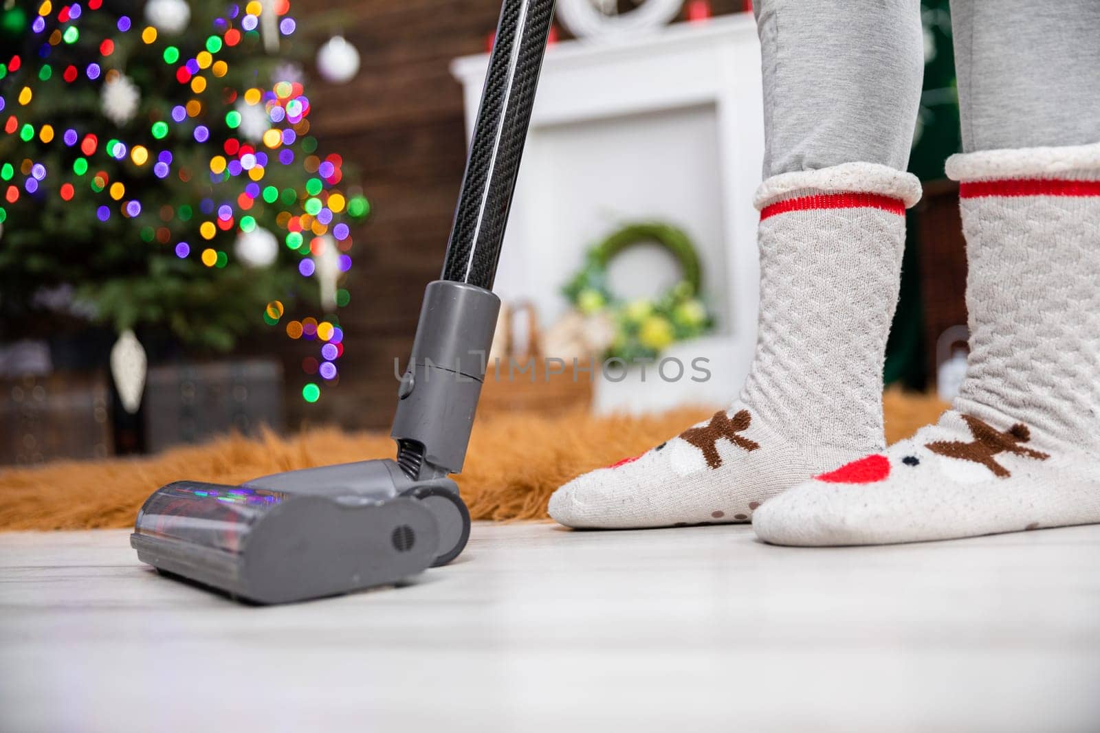 Thorough vacuuming of the floor before the celebration of an important Christian beheading. A decorated living room for Christmas.