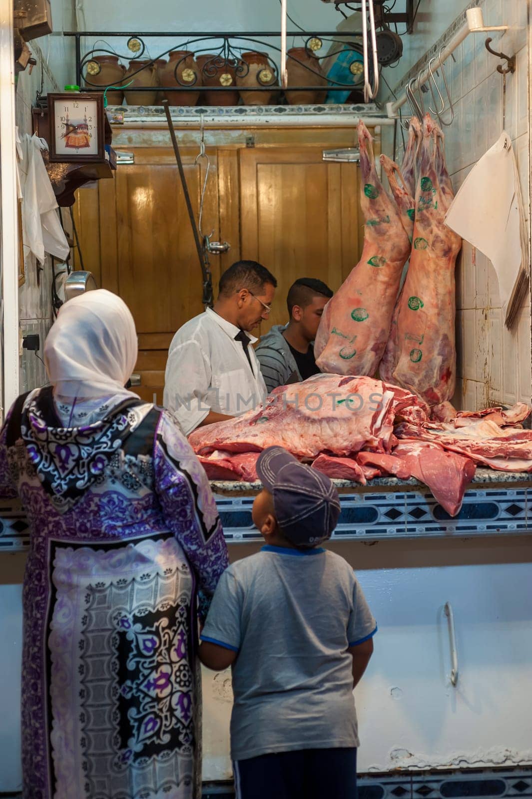 MARRAKECH, MOROCCO 09/08/2013 - Customers at a typical butcher's shop in Marrakech, Morocco