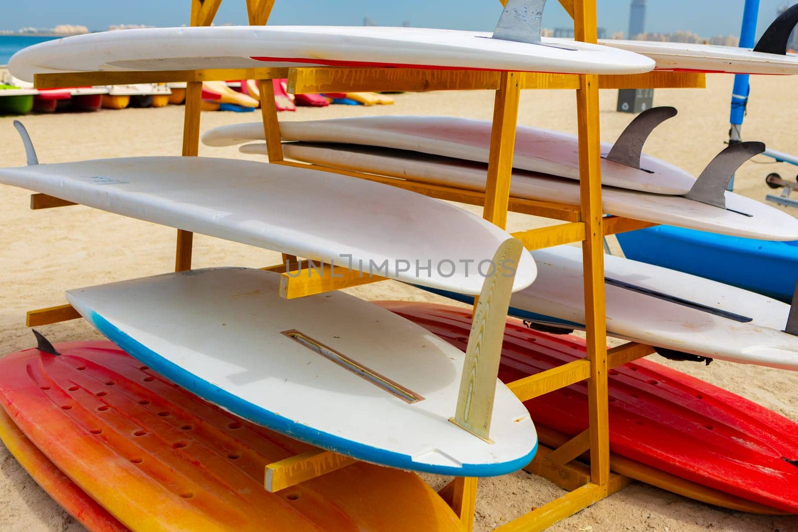 Surfboards stacked on the rack on a beach, close up