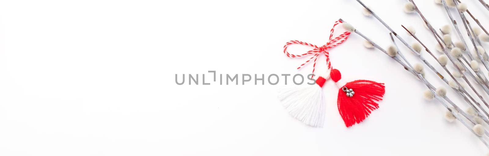 Banner Martenitsa, Baba Marta. Traditional Martisor Symbol of Holiday March 1 on White Background With Willow Twig.Grandma Marta Day Celebration In Romania,Bulgaria,Moldova. Red,white colored threads.