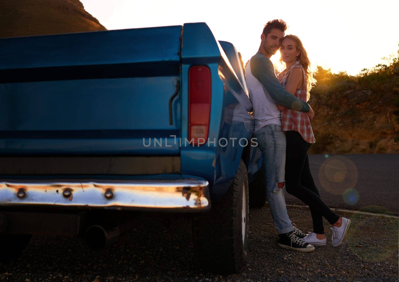 Couple, portrait and sunset by pickup truck for road trip with love, romance or date on adventure, travel or journey. Man, woman and hug for care, mockup and transportation for outdoor in countryside by YuriArcurs