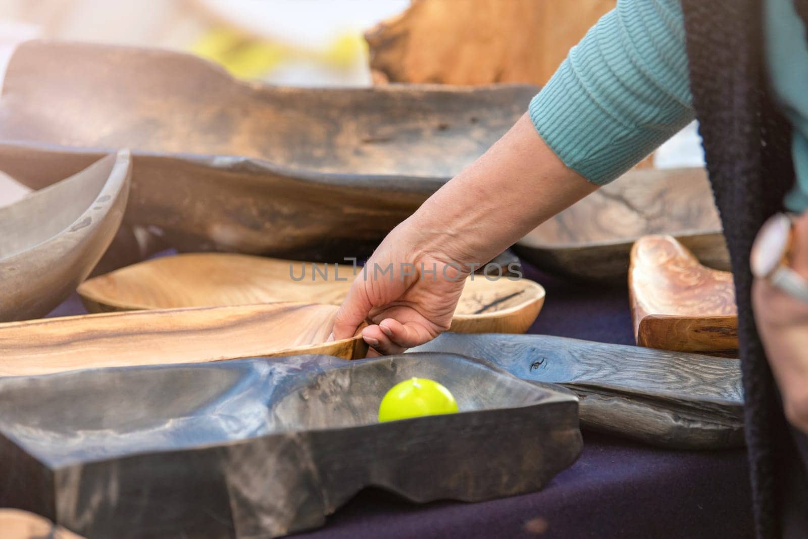 Manufacture and sale of wooden utensils. Large plates and trays made from exotic wood roots, handmade furniture and accessories purchase, craft and small business concept. High quality photo