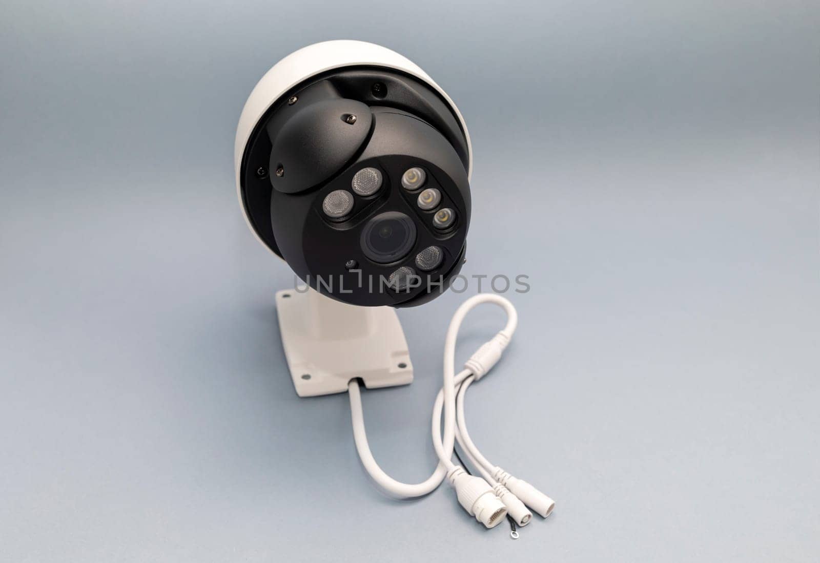 Surveillance IP Wireless Camera On Gray Background. Security Equipment For Smart Home With Online Remote App Monitoring. Protection Of Private Residential Building. Horizontal plane.High Quality Photo